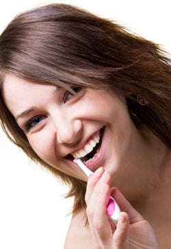 A woman brushing her teeth