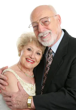 Elderly couple holding each other