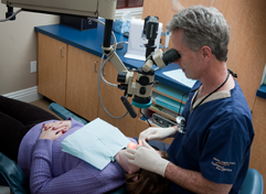 Dr. Poksay examining a patient's mouth