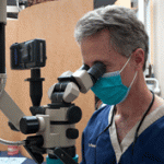 Dr. Poksay using dental equipment